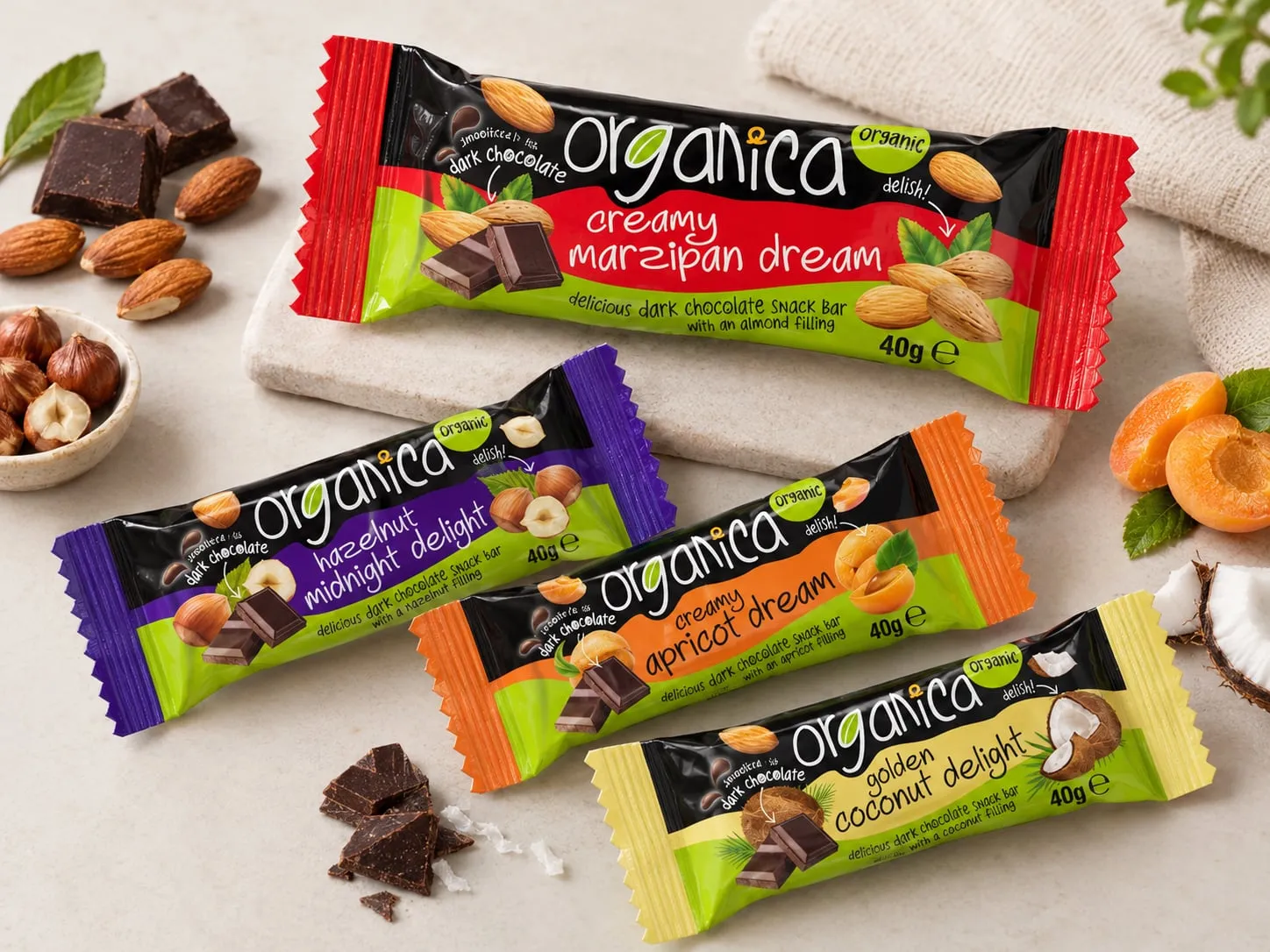 Organica dark chocolate snack bars: creamy marzipan dream, hazelnut midnight delight, creamy apricot dream and golden coconut delight, with almonds, hazelnuts and apricots.